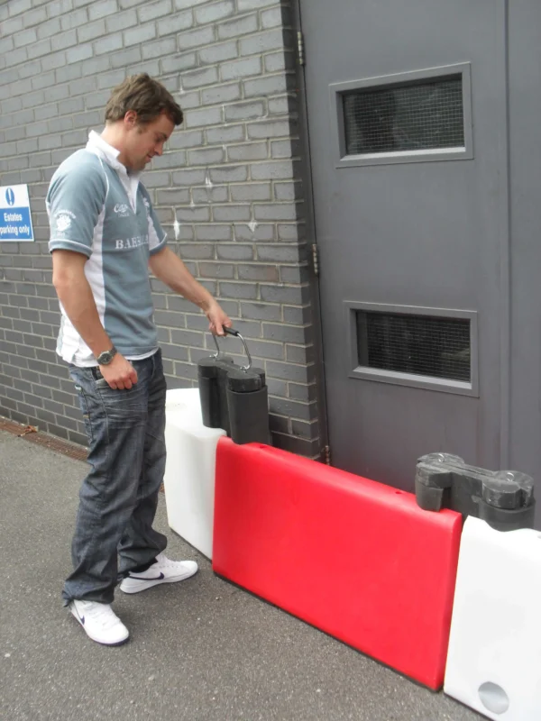 Person demonstrating how the key handle is used to pull the key out of the Floodstop barrier assembly